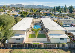 El Cajon apartment for rent - A large white building with a pool in the middle of it.