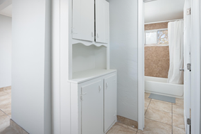 El Cajon apartment for rent - A white bathroom with a shower and a cabinet.