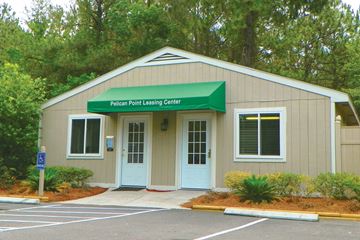 St. Marys apartment for rent - a building with a green awning and a parking lot