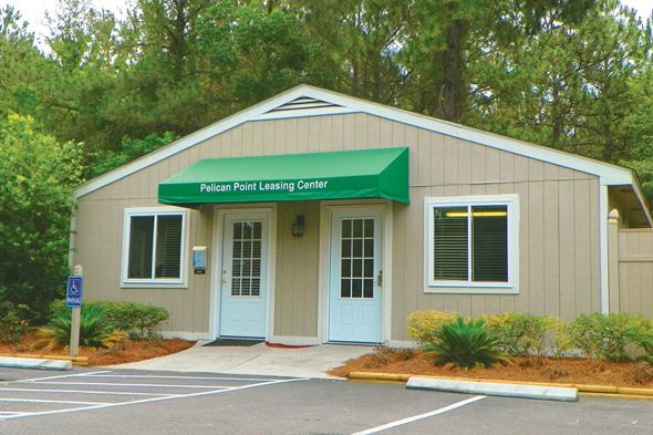 St. Marys apartment for rent - a building with a green awning and a parking lot