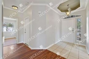 Leander house for rent - A room with a white door and a window with a view of trees.