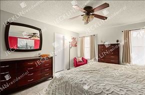 Pflugerville house for rent - A bedroom with a bed, dresser, and mirror.