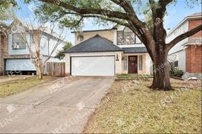 Pflugerville house for rent - A house with a driveway and a tree in front.
