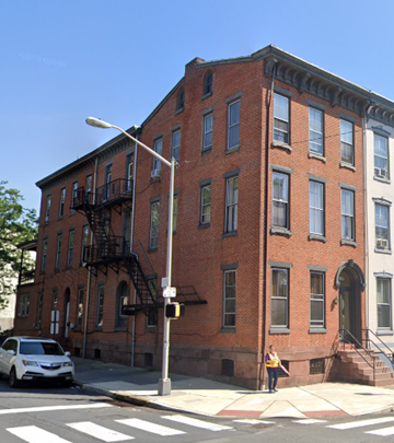 Reading apartment for rent - a woman standing in front of a brick building