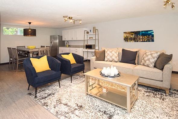 Portland apartment for rent - a living room with a couch and chairs and a table