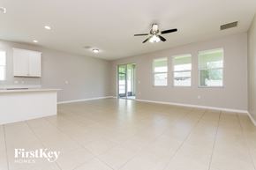 Orlando house for rent - A spacious room with a ceiling fan and tiled flooring.