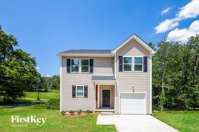 Gastonia house for rent - a tan house with a white garage door