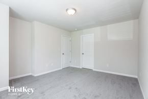 Gastonia house for rent - a bedroom with a carpeted floor and two doors