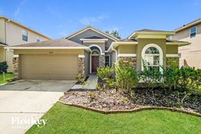 Land O Lakes house for rent - A house with a brown roof and a garage door that says "TRIBE".