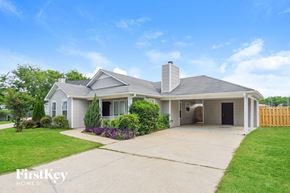 Helena house for rent - A house with a grey roof and a white chimney is for sale.