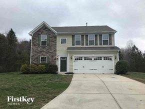 Gastonia house for rent - a two story house with a white garage door