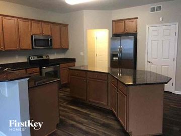 Gastonia house for rent - a kitchen with a counter top and a refrigerator