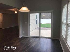 Gastonia house for rent - an empty living room with a sliding glass door
