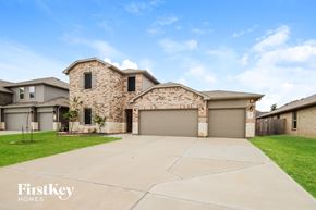Conroe house for rent - A house with a stone pillar in front of it.