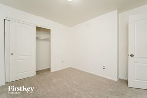 Tucson house for rent - a bedroom with white walls and a closet and white doors