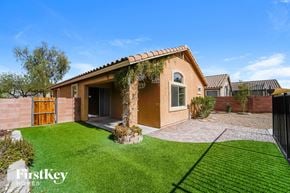 Tucson house for rent - a house with a yard and grass in front of it
