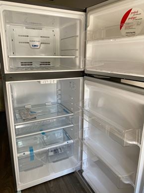 Louisville house for rent - A white refrigerator with the door open showing the empty shelves.