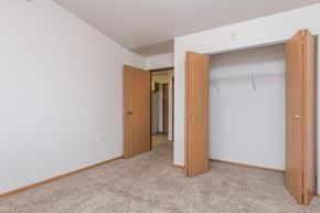 West Fargo apartment for rent - an empty bedroom with two doors and a closet