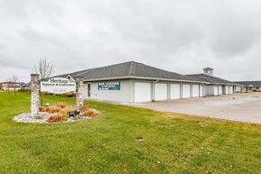 West Fargo apartment for rent - the front of a building with a sign in the grass