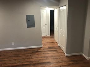 St. Louis apartment for rent - a living room with a hard wood floor and a door to a hallway