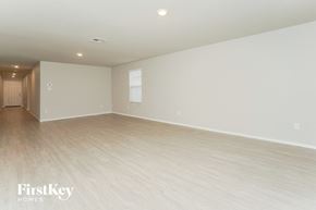 San Antonio house for rent - an empty living room with white walls and wood flooring