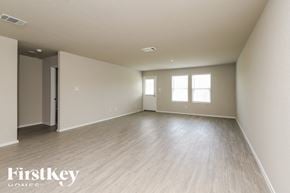 San Antonio house for rent - A spacious room with wooden flooring and a doorway leading to another room.