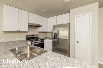 San Antonio house for rent - A kitchen with a stainless steel sink and refrigerator.