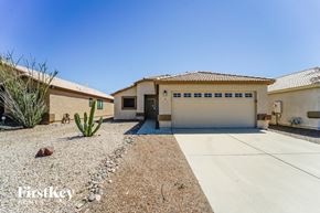 Tucson house for rent - a house with a driveway and a garage door