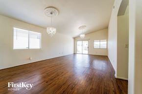 Tucson house for rent - an empty living room with wood floors and white walls