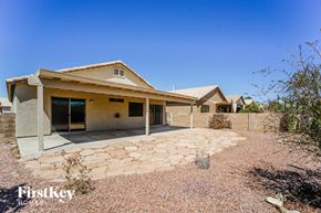 Tucson house for rent - a home with a stone walkway and a house next to it