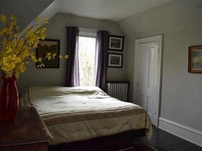 New Glasgow apartment for rent - a bedroom with a bed and a vase of flowers