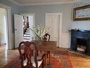 New Glasgow apartment for rent - a dining room with a table and chairs and a fireplace