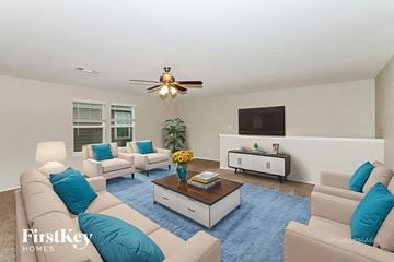 Hockley house for rent - A living room with a blue rug and a ceiling fan.