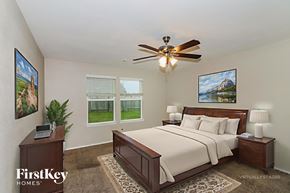Hockley house for rent - A bedroom with a bed, nightstand, and a ceiling fan.