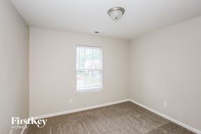 Matthews house for rent - a bedroom with a carpeted floor and a window
