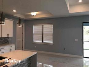 Lehigh Acres house for rent - A kitchen with a countertop and a window with blinds.