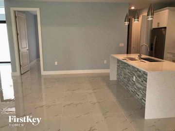Lehigh Acres house for rent - A kitchen with a white counter top and a sink.