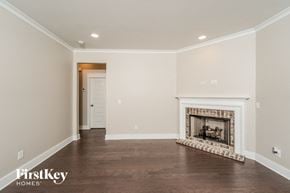 Birmingham house for rent - A spacious living room with a fireplace and wooden flooring.