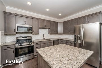 Birmingham house for rent - A kitchen with a granite countertop and stainless steel appliances.