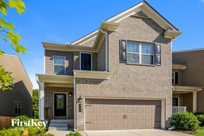 Lawrenceville house for rent - a tan brick house with a garage door