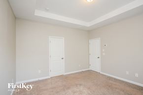 Lawrenceville house for rent - a bedroom with two doors and a carpeted floor