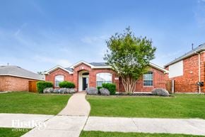 Rowlett house for rent - a brick house with a sidewalk in front of it