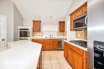 Rowlett house for rent - a kitchen with wooden cabinets and a white counter top