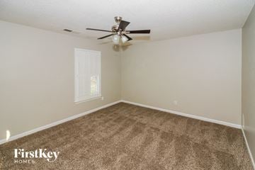 Memphis house for rent - the spacious living room with carpet and a ceiling fan