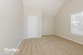 Stockbridge house for rent - the bedroom of a home with a white door and carpet