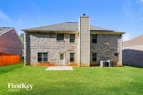 Stockbridge house for rent - an old brick house with a grassy yard and a barn