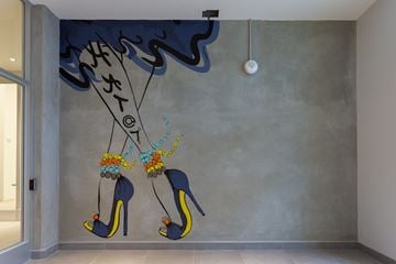 Calgary apartment for rent - A wall mural of high heel shoes with flowers on them.