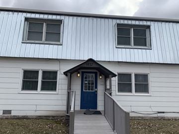 Fremont apartment for rent - A white house with a blue door and windows.