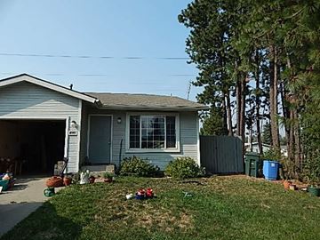 Post Falls house for rent - a blue house with a yard and a garage