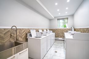 Montreal apartment for rent - A modern bathroom with a stainless steel sink and white cabinets.